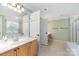 Bright main bathroom featuring double sinks, ample counter space, and a glass enclosed shower at 1002 Hollyhedge Ln, Indian Trail, NC 28079