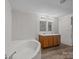 Bathroom with a corner tub, double vanity, and vinyl flooring at 1011 Rachel Ln, Salisbury, NC 28147