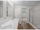 Bright bathroom featuring a double sink vanity, vinyl flooring, and glass shower at 1011 Rachel Ln, Salisbury, NC 28147