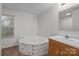 Bathroom featuring a corner tub and wood vanity at 1011 Rachel Ln, Salisbury, NC 28147