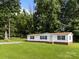 Well-maintained single-story home with a large, grassy front yard and tree coverage at 1011 Rachel Ln, Salisbury, NC 28147
