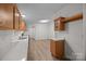 Well-lit kitchen featuring ample counter space, wooden cabinets, and hardwood floors at 1011 Rachel Ln, Salisbury, NC 28147