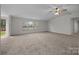 Spacious living room with plush carpeting, a ceiling fan, and ample natural light at 1011 Rachel Ln, Salisbury, NC 28147