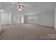Open-concept living room with neutral walls, carpet, and a ceiling fan at 1011 Rachel Ln, Salisbury, NC 28147