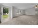 Bright living room featuring neutral carpeting, ceiling fan and an inviting open doorway at 1011 Rachel Ln, Salisbury, NC 28147