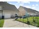 View of the backyard area, showing the fence, patio, and rear of the townhome at 1012 Laparc Ln, Indian Trail, NC 28079