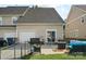 Backyard with patio, grill, and access to the garage through sliding glass doors at 1012 Laparc Ln, Indian Trail, NC 28079