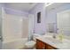 Cozy bathroom featuring a tub, shower, a vanity with a sink, toilet, and decorative wall art at 1012 Laparc Ln, Indian Trail, NC 28079