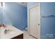 Bright bathroom with dual sinks, white cabinetry, and a separate toilet area for added privacy at 1012 Laparc Ln, Indian Trail, NC 28079