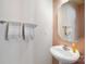 Bright half-bath with a pedestal sink, a framed mirror, and tiled flooring at 1012 Laparc Ln, Indian Trail, NC 28079