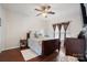 Inviting bedroom with a ceiling fan, dark wood floors, a large bed, and neutral-toned décor at 1012 Laparc Ln, Indian Trail, NC 28079