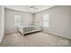 Sunny bedroom with ample natural light, neutral carpet, and a simple, elegant bed frame at 1012 Laparc Ln, Indian Trail, NC 28079
