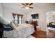 Comfortable bedroom featuring a ceiling fan, hardwood floors, a sizable bed, and natural light at 1012 Laparc Ln, Indian Trail, NC 28079