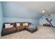 Bonus room provides flexible living space with comfortable seating, an exercise machine, and natural light at 1012 Laparc Ln, Indian Trail, NC 28079
