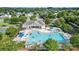 Aerial view of a sparkling community pool and clubhouse with ample seating at 1012 Laparc Ln, Indian Trail, NC 28079