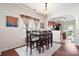 Dining room with wooden table, view into living room and modern light fixture at 1012 Laparc Ln, Indian Trail, NC 28079