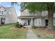 Charming two-story townhome with covered porch and landscaped front yard offering great curb appeal at 1012 Laparc Ln, Indian Trail, NC 28079