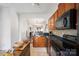 Open-concept kitchen featuring wood cabinets, a tile backsplash, and seamless access to the connected living area at 1012 Laparc Ln, Indian Trail, NC 28079