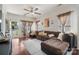 Bright living room featuring hardwood floors, a ceiling fan, and a large sectional sofa at 1012 Laparc Ln, Indian Trail, NC 28079
