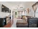 Cozy living room with hardwood floors, a large sectional sofa, and ample natural light at 1012 Laparc Ln, Indian Trail, NC 28079