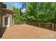 Spacious wooden back deck offers a private outdoor retreat with views of the surrounding greenery at 10321 Lemington Dr, Mint Hill, NC 28227