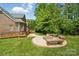 Brick home featuring a backyard with a fire pit and comfortable seating area at 10321 Lemington Dr, Mint Hill, NC 28227