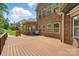 Brick home featuring a backyard with a deck and comfortable outdoor seating at 10321 Lemington Dr, Mint Hill, NC 28227