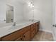 Bathroom with a long vanity, double sinks, a tile floor and a shower/tub combo at 10321 Lemington Dr, Mint Hill, NC 28227