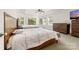 Spacious bedroom with two beds, a ceiling fan, a dresser, and natural light from large windows at 10321 Lemington Dr, Mint Hill, NC 28227