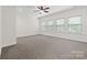 Spacious primary bedroom with large windows offering ample natural light and neutral carpet at 10321 Lemington Dr, Mint Hill, NC 28227
