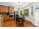 Breakfast nook with hardwood floors, natural light from a large window, and a wooden dining table at 10321 Lemington Dr, Mint Hill, NC 28227