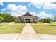Beautiful clubhouse with manicured landscaping and a welcoming walkway at 10321 Lemington Dr, Mint Hill, NC 28227