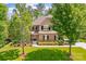 Beautiful two-story home with brick facade, green lawn, and mature trees adding to its appeal at 10321 Lemington Dr, Mint Hill, NC 28227