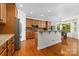 Well-lit kitchen featuring wooden cabinets, granite countertops, stainless steel appliances, and hardwood floors at 10321 Lemington Dr, Mint Hill, NC 28227