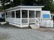 Exterior showing the white picket fence and the covered porch of the home at 109 Pine St, New London, NC 28127