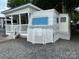 Exterior shows a park model trailer with white lattice and a porch with stairs and white railing at 109 Pine St, New London, NC 28127