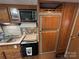 Well-equipped kitchen with appliances, wooden cabinets, sink and oven at 109 Pine St, New London, NC 28127