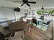 Covered porch with seating and dining areas, complete with TV and outdoor storage at 109 Pine St, New London, NC 28127