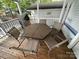 Dining area on the covered porch with grill at 109 Pine St, New London, NC 28127
