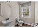 Powder room with pedestal sink, hardwood floors, and natural light from a window at 126 Northbridge Dr, Mooresville, NC 28115