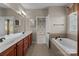 Spacious bathroom with double sink vanity, garden tub, and neutral tile flooring at 126 Northbridge Dr, Mooresville, NC 28115
