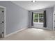 This bedroom has neutral walls, carpet, and natural light at 126 Northbridge Dr, Mooresville, NC 28115