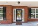 Close-up of the front door with decorative glass and brick surround at 126 Northbridge Dr, Mooresville, NC 28115