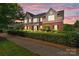 Beautiful two-story home featuring brick and stone accents, a covered porch, and mature landscaping at 126 Northbridge Dr, Mooresville, NC 28115