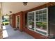 Inviting front porch showcasing brick accents, a covered entrance, and exterior lighting at 126 Northbridge Dr, Mooresville, NC 28115