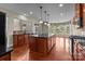 Spacious kitchen with wooden cabinetry, granite countertops, a large island, and hardwood floors at 126 Northbridge Dr, Mooresville, NC 28115