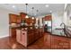 Spacious kitchen with wood cabinets, granite countertops, an island, and hardwood floors at 126 Northbridge Dr, Mooresville, NC 28115