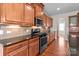This kitchen features stainless steel appliances, granite countertops, and ample storage in wooden cabinets at 126 Northbridge Dr, Mooresville, NC 28115