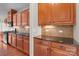 Kitchen area featuring wood cabinets, granite countertops, and tiled backsplash at 126 Northbridge Dr, Mooresville, NC 28115