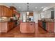 Large open kitchen with wood cabinetry, island, and stainless steel appliances at 126 Northbridge Dr, Mooresville, NC 28115